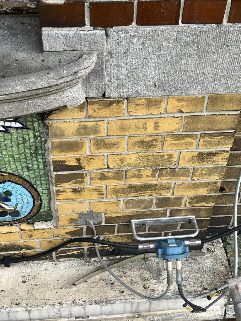 "Typical yellow facade bricks from a 1920's house in Belgium. Dirty from air polution and city smog, from the city of Antwerp (Belgium). Test section with Alkaline based chemical cleaner, washed of with high pressure washer and cold water. The brush marks are very clear.